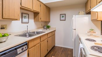Cantera spacious kitchen with sink, stove, fridge, and plenty of cabinetry